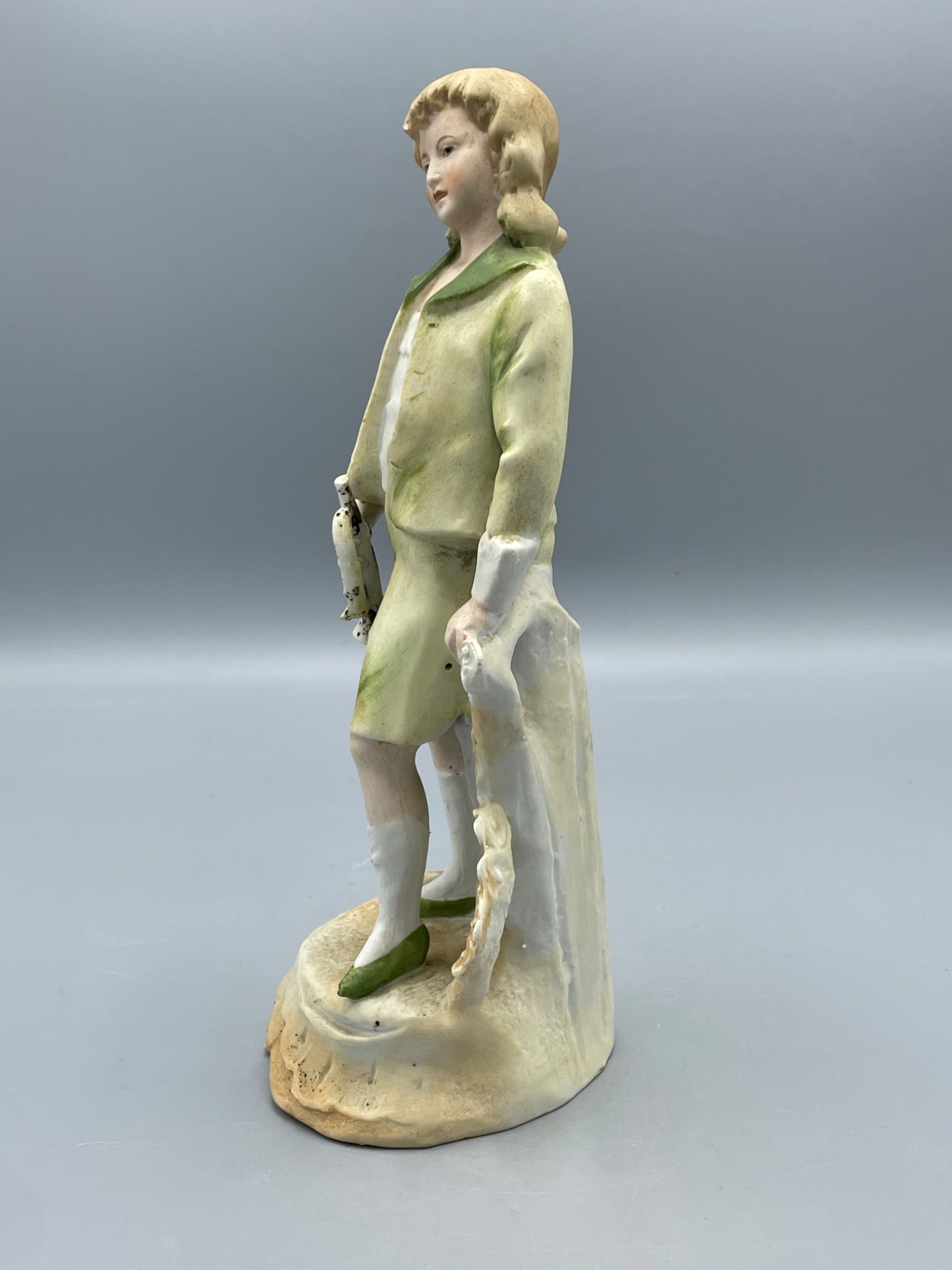 Porcelain Figurine of Boy Holding Horseshoe with Green and Yellow Outfit - 4