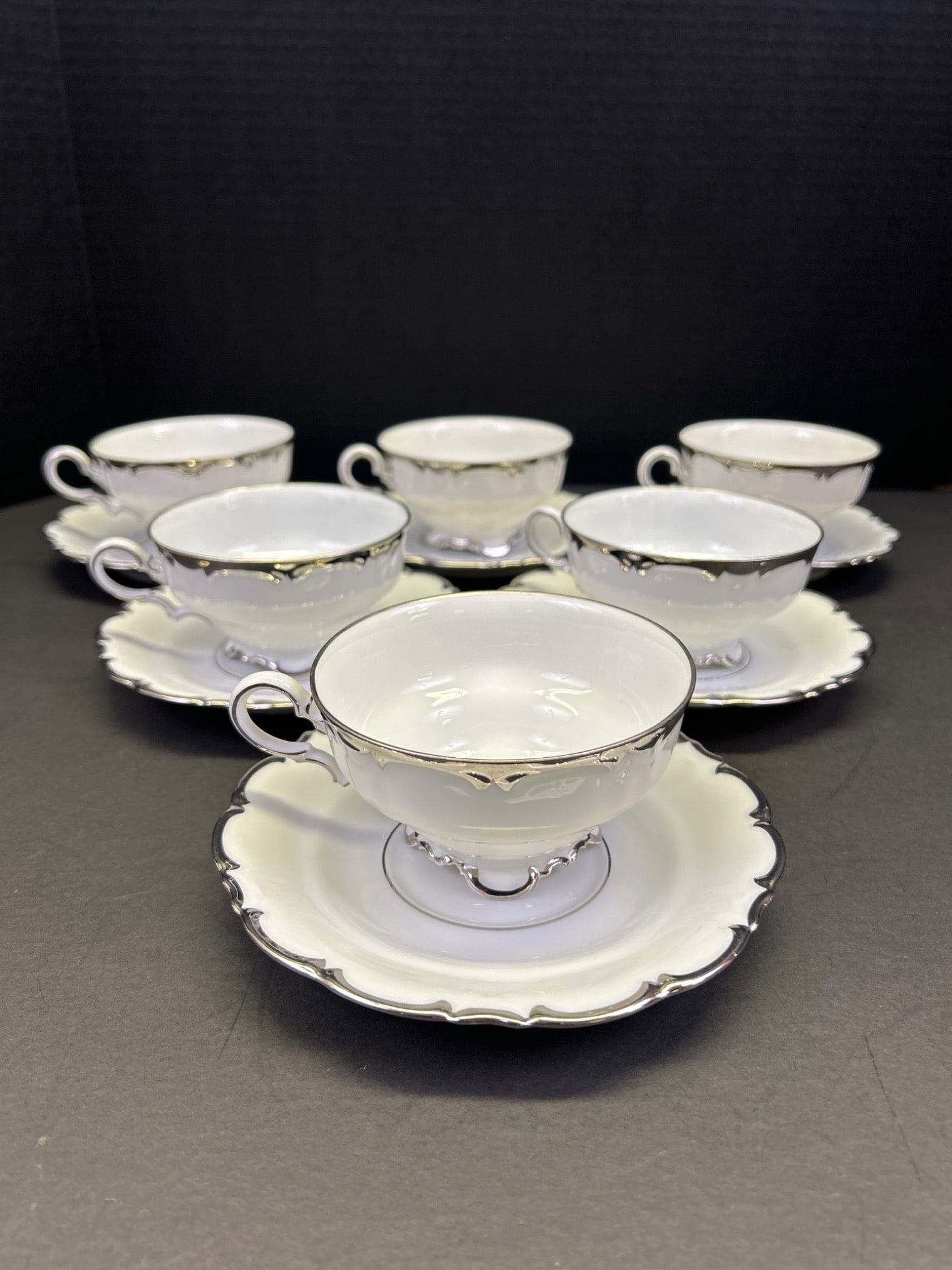 6 Hutschenreuther Selb Bavaria Teacups and Saucers, 2797 45: This lot features a set of six teacups and matching saucers from Hutschenreuther, marked with 'Hutschenreuther Selb Bavaria Germany' and pattern number '2797 45'. The teacups and saucers have a white