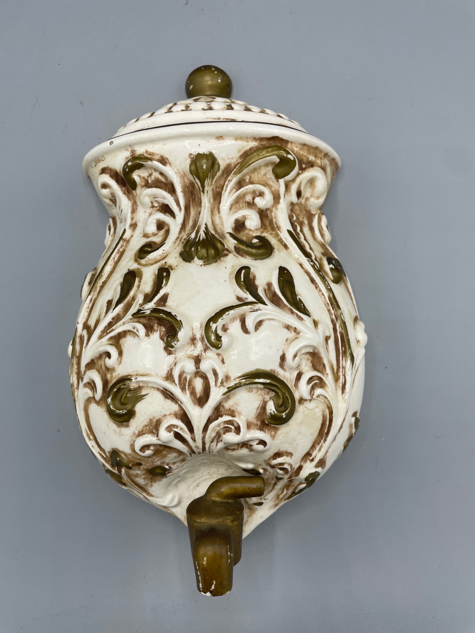 Arnelâ€™s Art Creation Japan Ceramic Wall decor with Relief Pattern: Ceramic wall-mounted decor made by Arnelâ€™s Art Creation (Japan), featuring an ornate relief design in green and cream tones. The back includes a manufacturer label. Measures