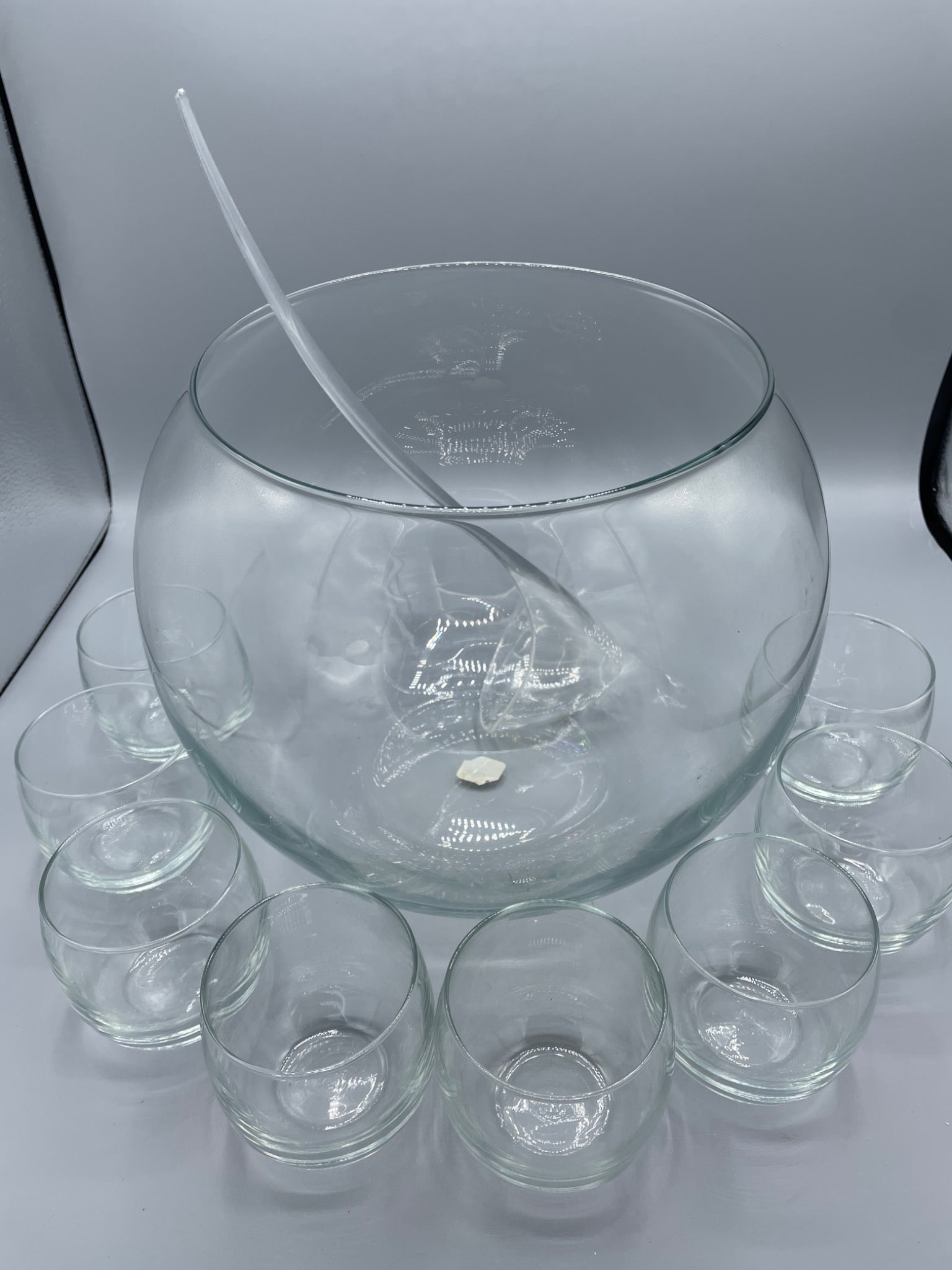10-Piece All-Glass Punch Bowl Set By Crate & Barrel, Model 293-458: This 10-piece punch bowl set includes one large bowl, eight matching glasses, and one ladle. Manufactured by Crate & Barrel (Model 293-458), the set is made entirely of glass. The punch bowl measures