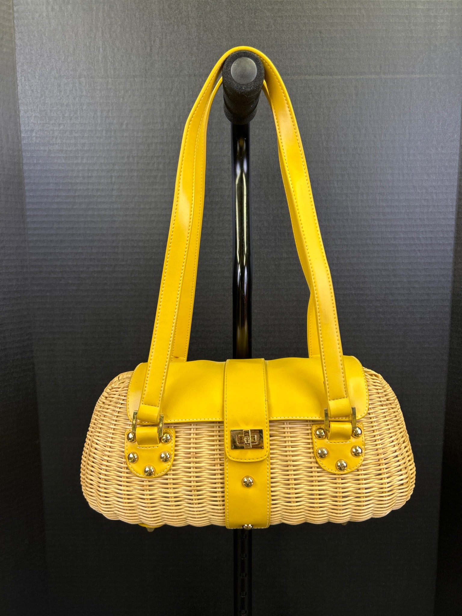 Etienne Aigner Yellow Handle Wicker Bag With Floral Interior: Etienne Aigner wicker handbag with yellow leather trim and handles. Features zippered and open pockets in a brightly colored fabric interior with floral patterns. Retains the original tag indicating