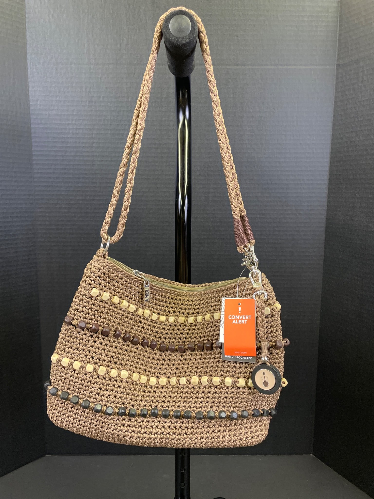 The Sak Hand-Crocheted Vegan Shoulder Bag with Beaded Detailing: This is a hand-crocheted shoulder bag by The Sak featuring vegan materials and detailed with beads. It includes a zippered main compartment, interior pocketing, and an exterior zipper pocket on the