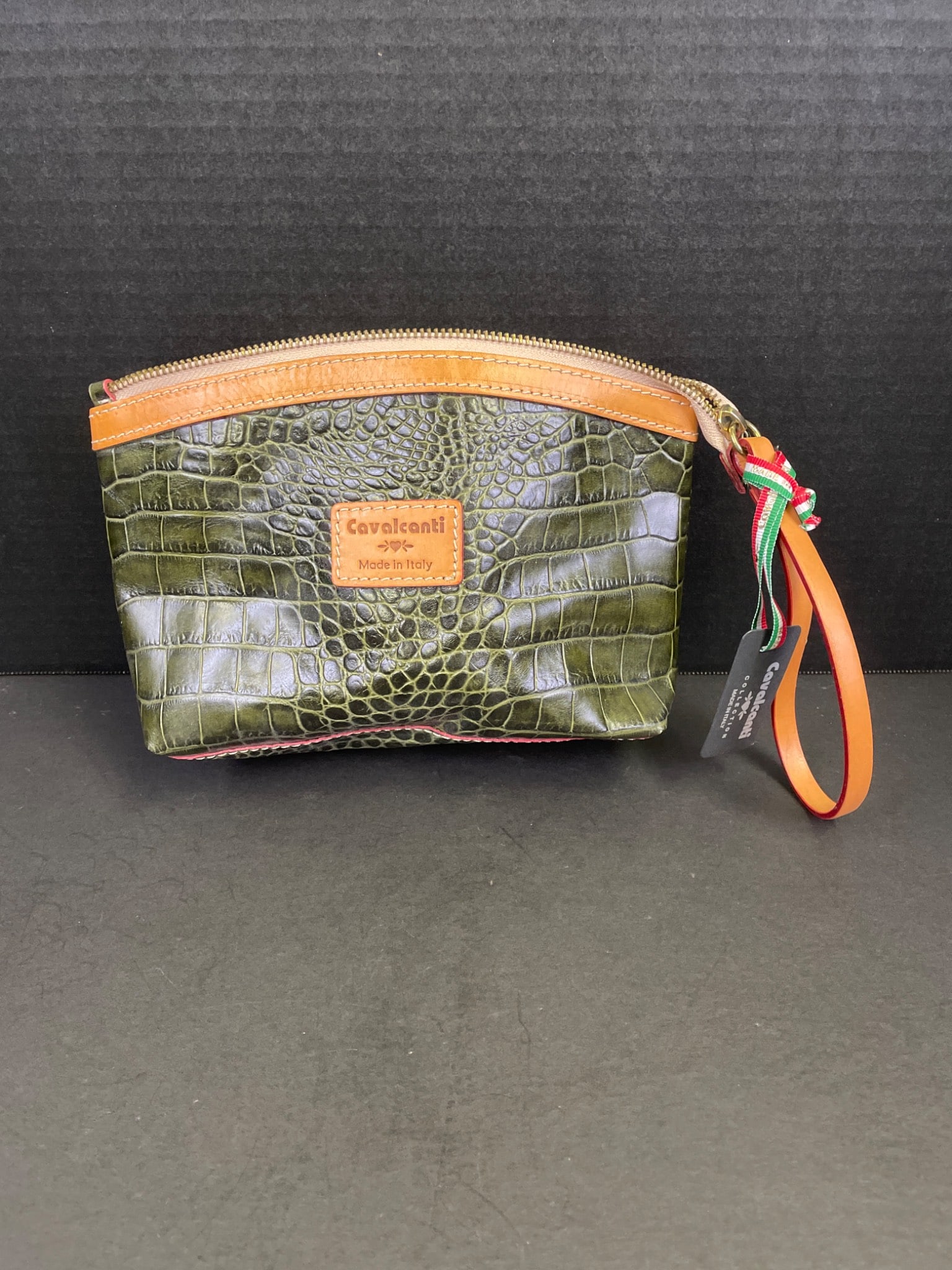 Cavallanti Green Croc-Embossed Leather Pouch with Polka Dot Lining: Cavallanti green croc-embossed leather pouch featuring a zippered closure, polka dot fabric interior lining, and leather pull strap. Includes original manufacturer tag indicating 'Made in Italy'.