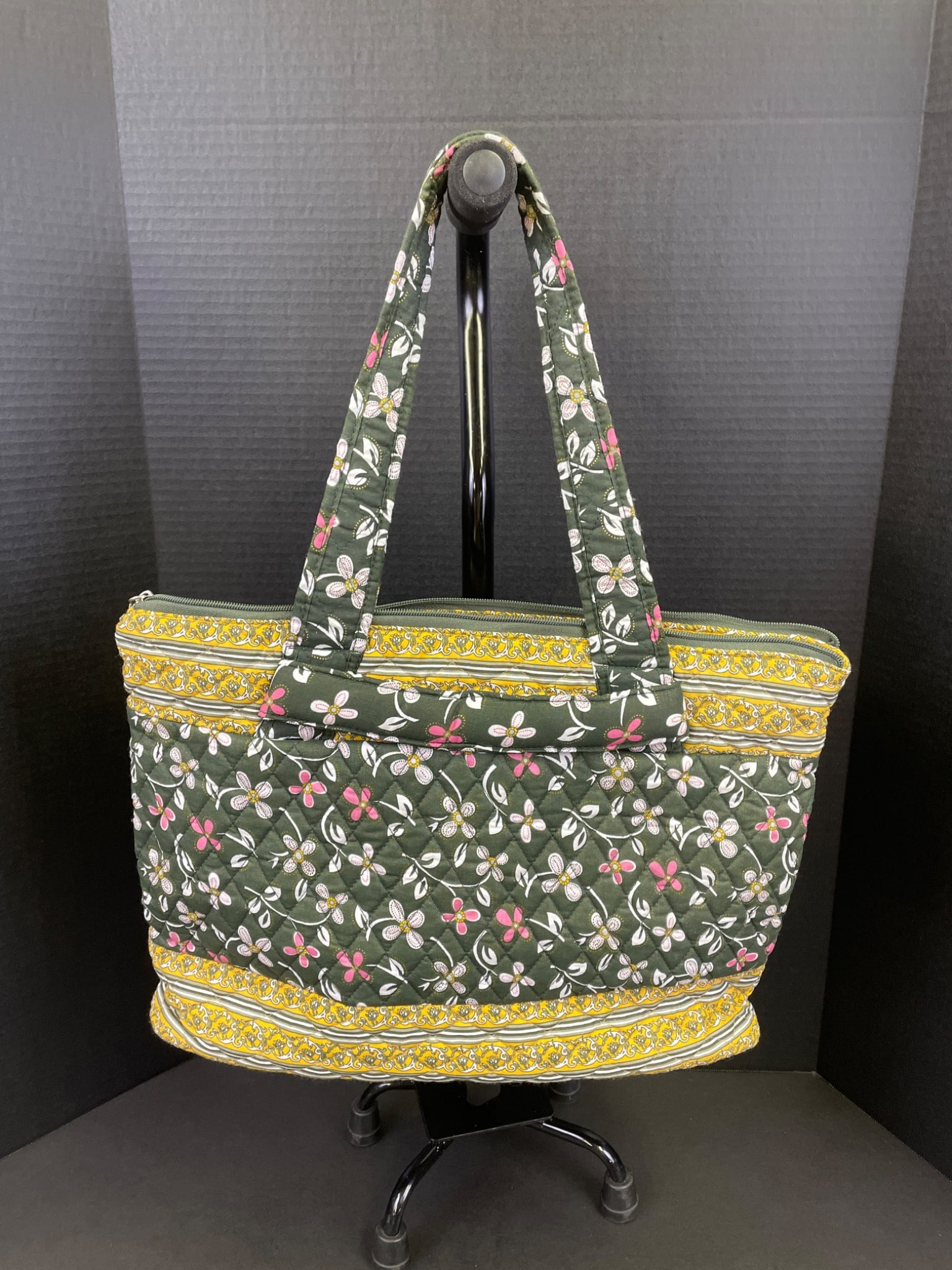 Travelon North Shore Collection Tote Bag With Floral Print: Travelon North Shore Collection Tote Bag featuring a floral print design. Includes an organized interior with multiple pockets, zipper closure, and green fabric lining. Dimensions are 17 in x 12 in x