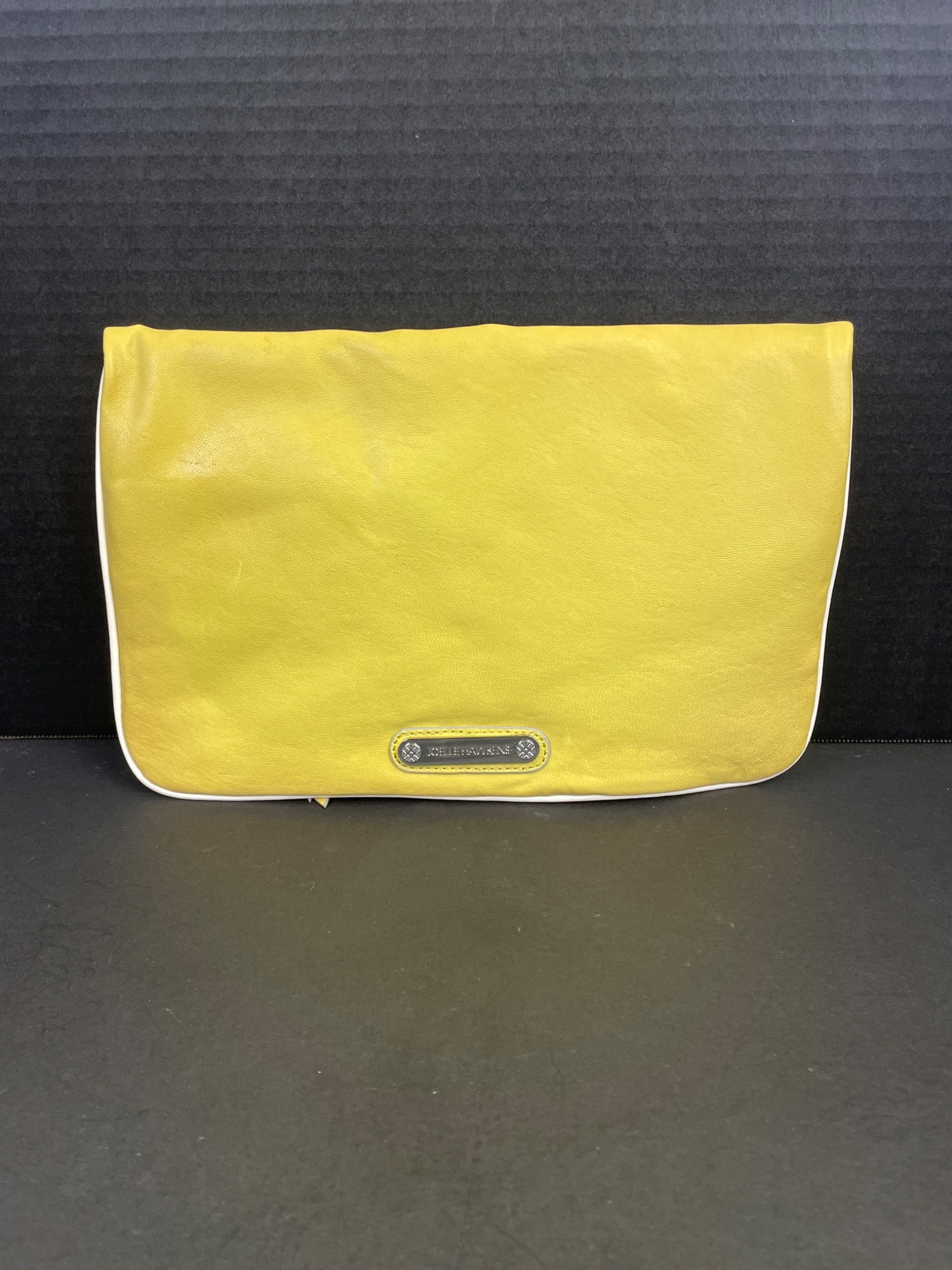 Botkier Cosmic Convertible Clutch in Yellow with Tag: Botkier Cosmic Convertible Clutch in yellow featuring a fold-over design with a magnetic snap closure. Includes a zippered main compartment and a lined interior. Item retains the original tag showing 