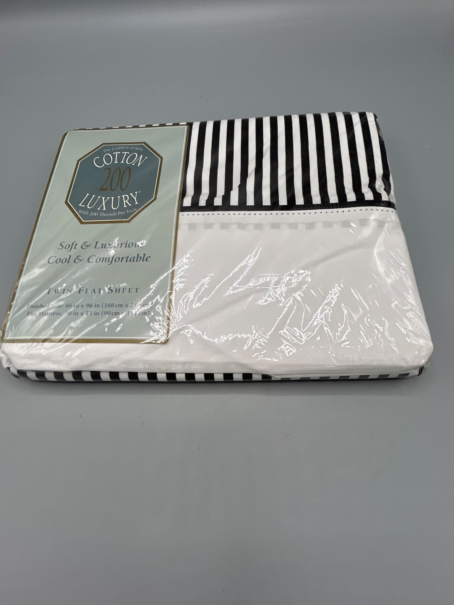 Cotton Luxury 200 Thread Count Twin Flat Sheet - Classic LN Black: This Cotton 200 Luxury twin flat sheet is made of 60% cotton and 40% polyester. It has a thread count of 200 for a soft and comfortable feel. The dimensions of the sheet are 66 in x 96 in (168 cm x