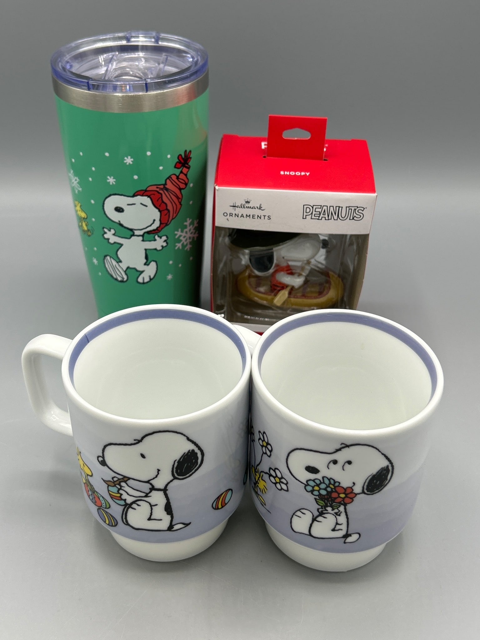 Peanuts Snoopy Mug Set, Tumbler, and Hallmark Ornament, New: This lot features brand-new items including a set of two ceramic Snoopy mugs (dishwasher and microwave safe, 2021 Peanuts Worldwide LLC, made in China), a stainless steel Snoopy tumbler