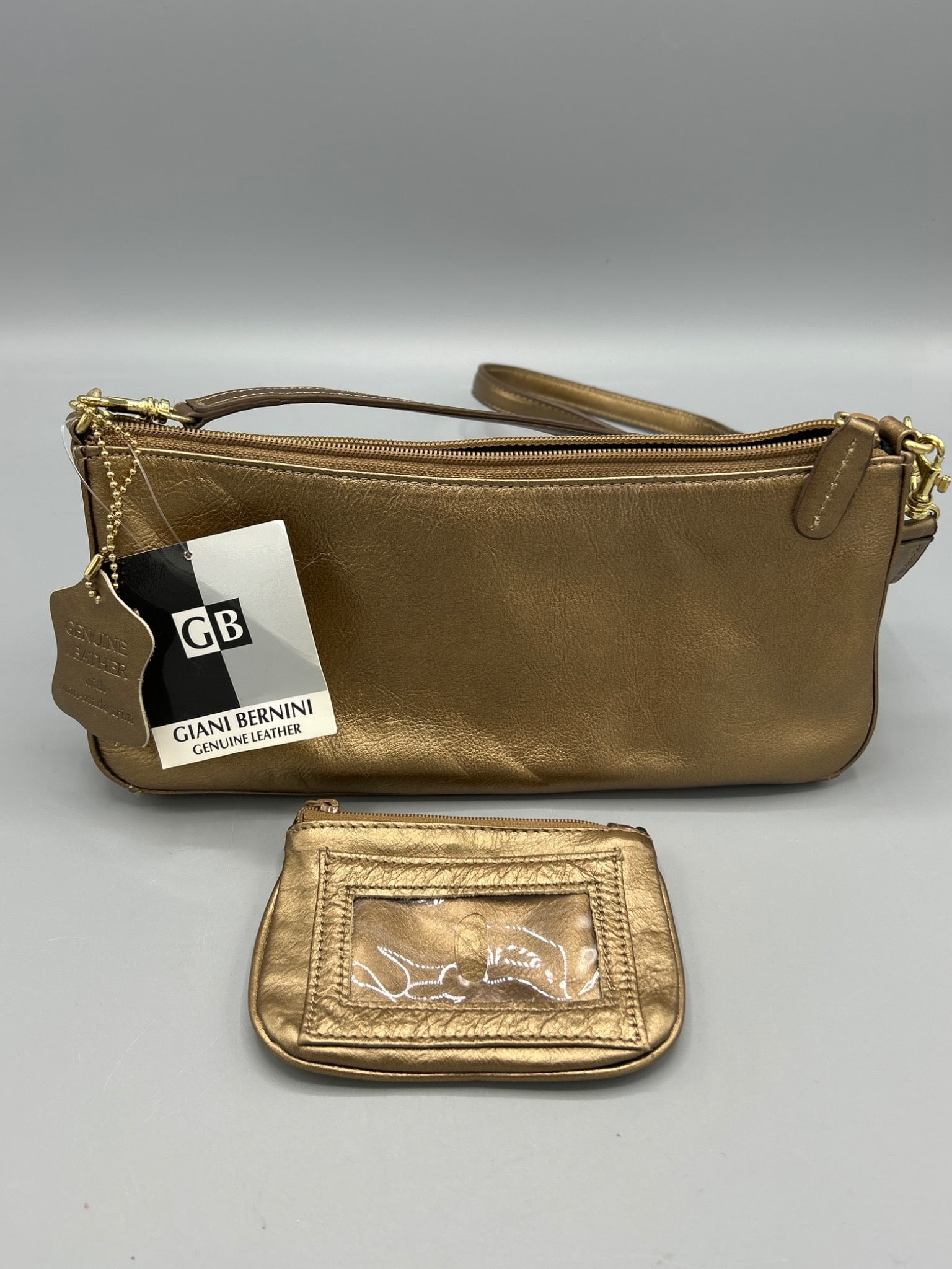 Giani Bernini Genuine Leather Shoulder Bag With Coin Pouch: Giani Bernini genuine leather shoulder bag in metallic bronze finish. The set includes a matching detachable coin pouch with a clear ID window. The shoulder strap is adjustable. Interior features