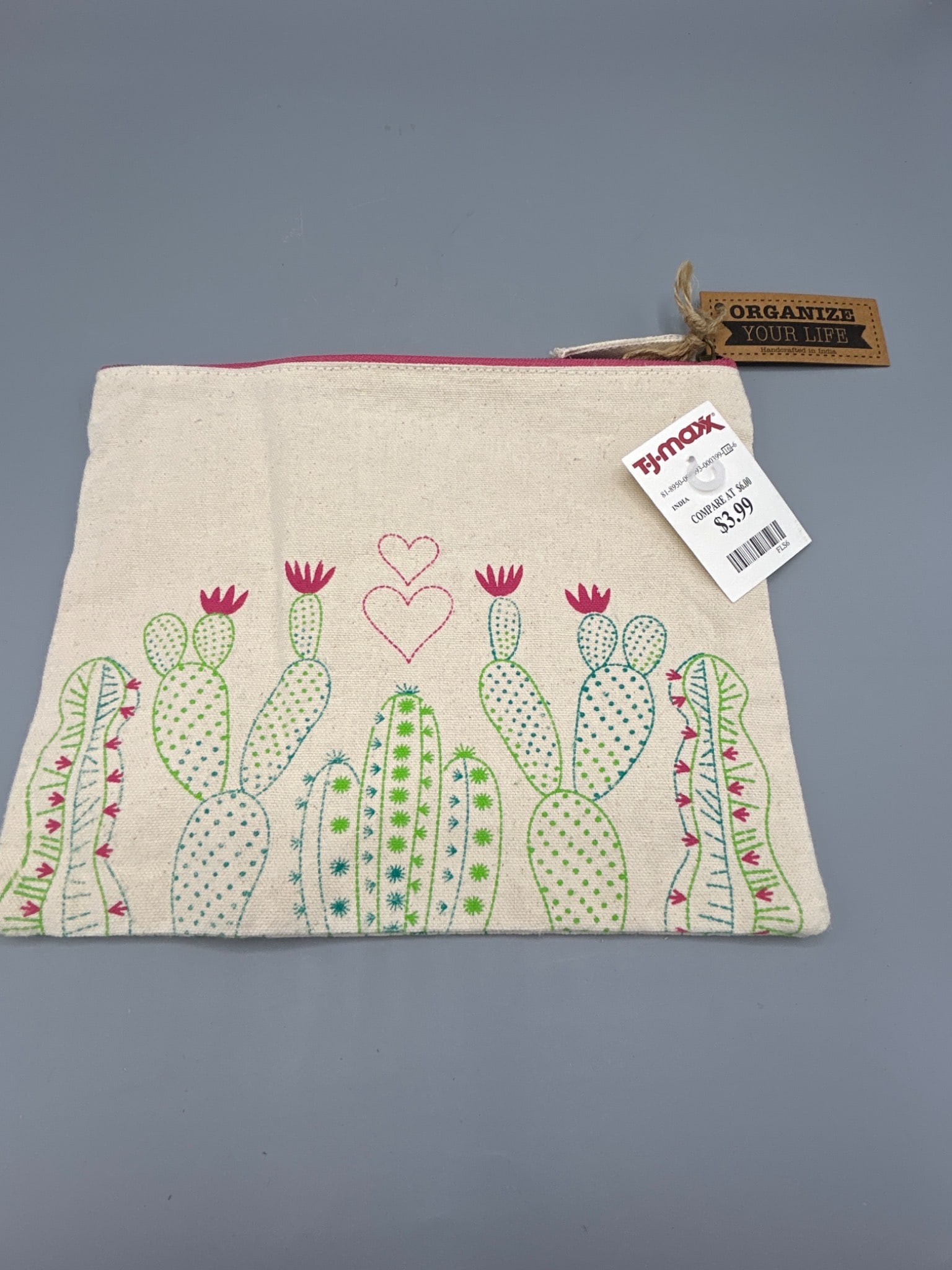 Handcrafted Cotton Pouch With Cactus Design, Made in India: This cotton pouch features colorful cactus embroidery and measures approximately 9 inches in width by 8 inches in height. It is uniquely handcrafted and includes a zipper closure with a tag reading