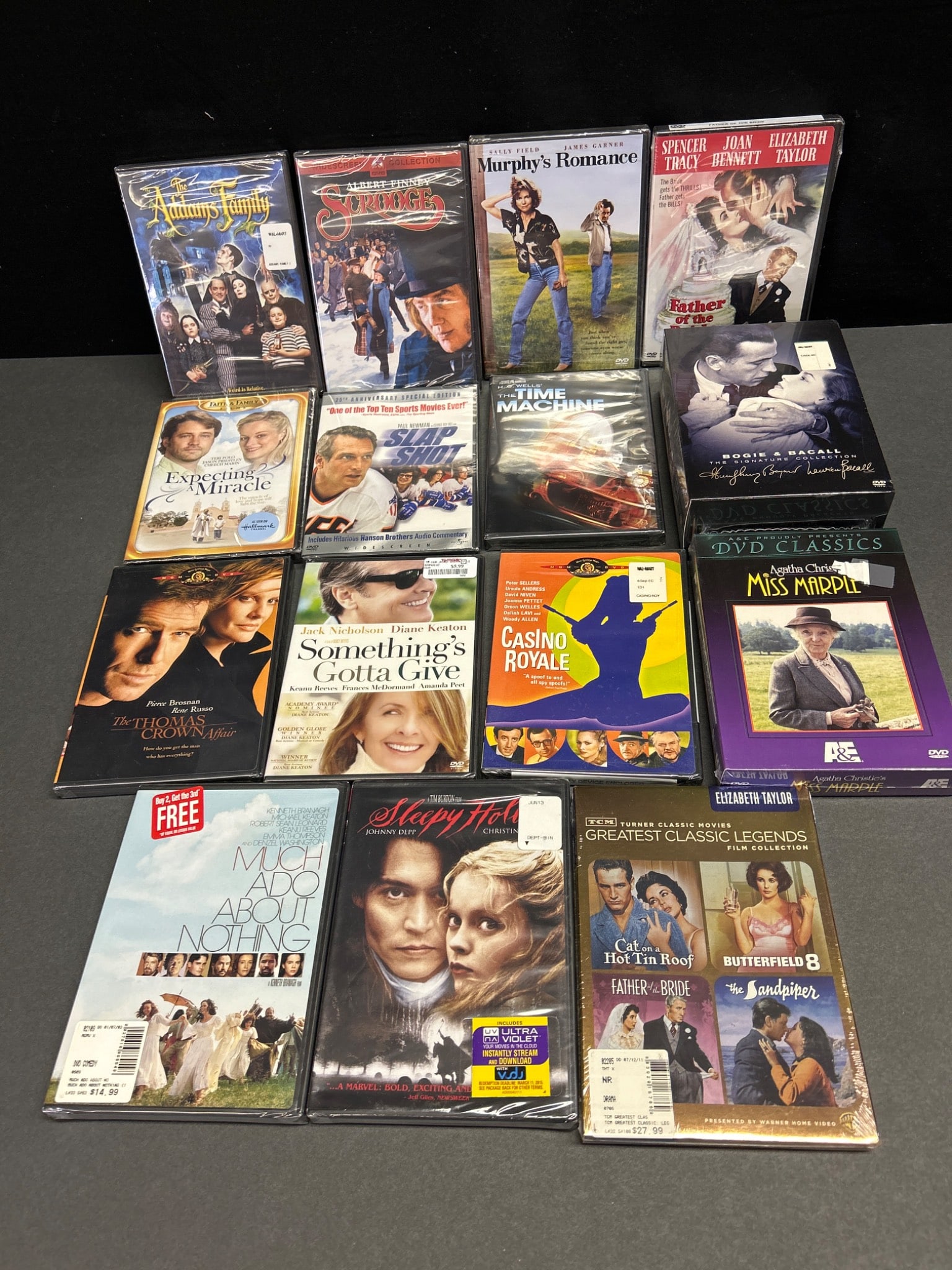 Sealed DVDs Including Various Titles and Genres: This auction lot features a collection of sealed DVDs, including titles such as 'The Addams Family,' 'Scrooge,' 'Sleepy Hollow,' and 'Casino Royale,' among others. The collection spans a variety of ge