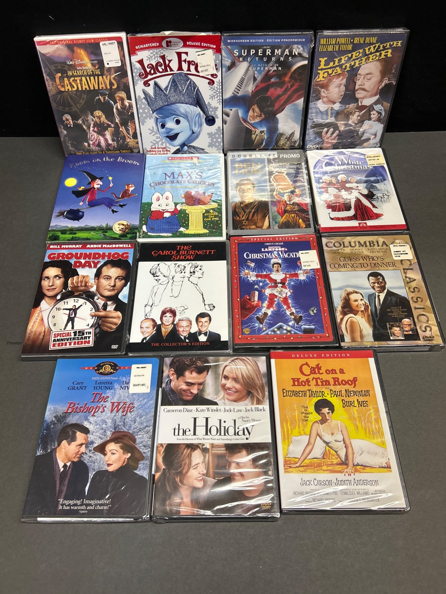 16 Sealed DVDs Including Classics and Holiday Titles: This lot features 16 sealed DVDs, with a mix of classic films, holiday specials, and family favorites. Titles include 'Groundhog Day,' 'Superman Returns,' 'The Holiday,' 'The Bishop's Wife,' and more.