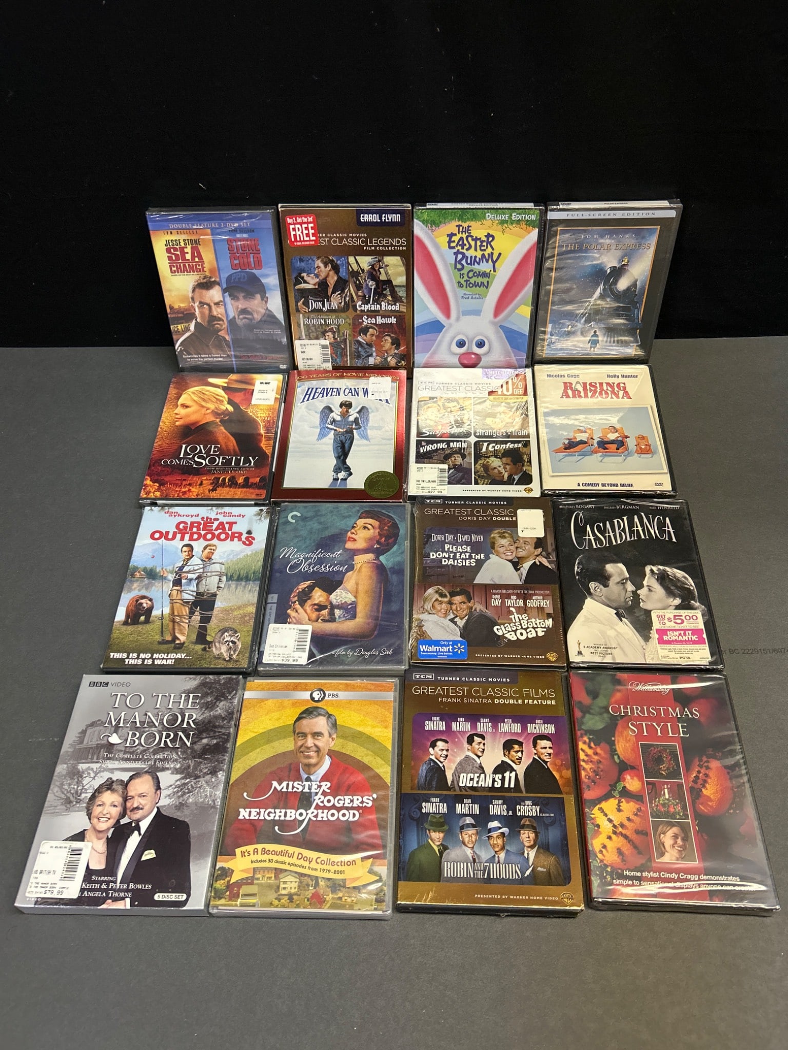 Sealed DVDs Including Movies and TV Series: Sealed DVDs including titles such as 'Casablanca', 'The Polar Express', 'Love Comes Softly', 'The Great Outdoors', 'The Easter Bunny Is Coming to Town', and 'Mister Rogers' Neighborhood'. Some DVDs ar
