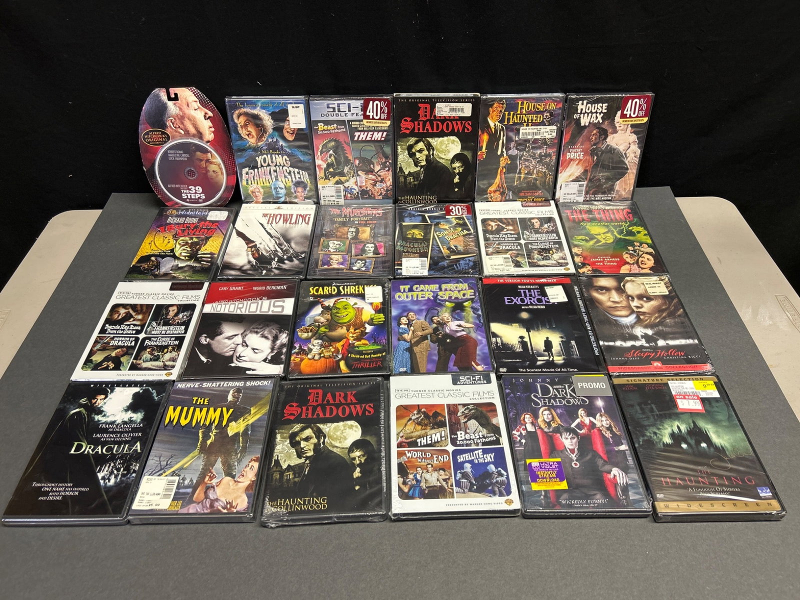 Sealed Horror DVDs Including Multiple Titles: This lot includes approximately 30 horror DVDs, all sealed. Titles include 'The Exorcist,' 'The Thing,' 'House of Wax,' 'The Haunting,' 'Young Frankenstein,' 'It Came from Outer Space,' 'Dark Shadows,