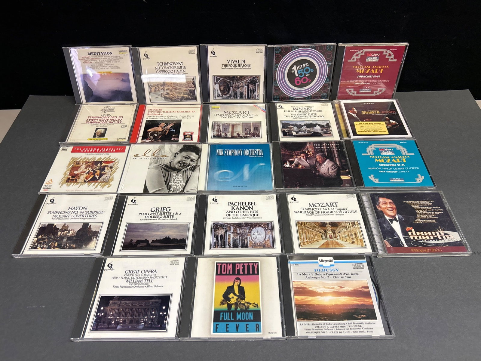 20 Classical and Popular Music CDs Featuring Varied Composers and Artists: This lot features a collection of 20 CDs encompassing a mix of classical compositions and popular music. Notable titles include works by Tchaikovsky, Mozart, Vivaldi, and Grieg, as well as popular