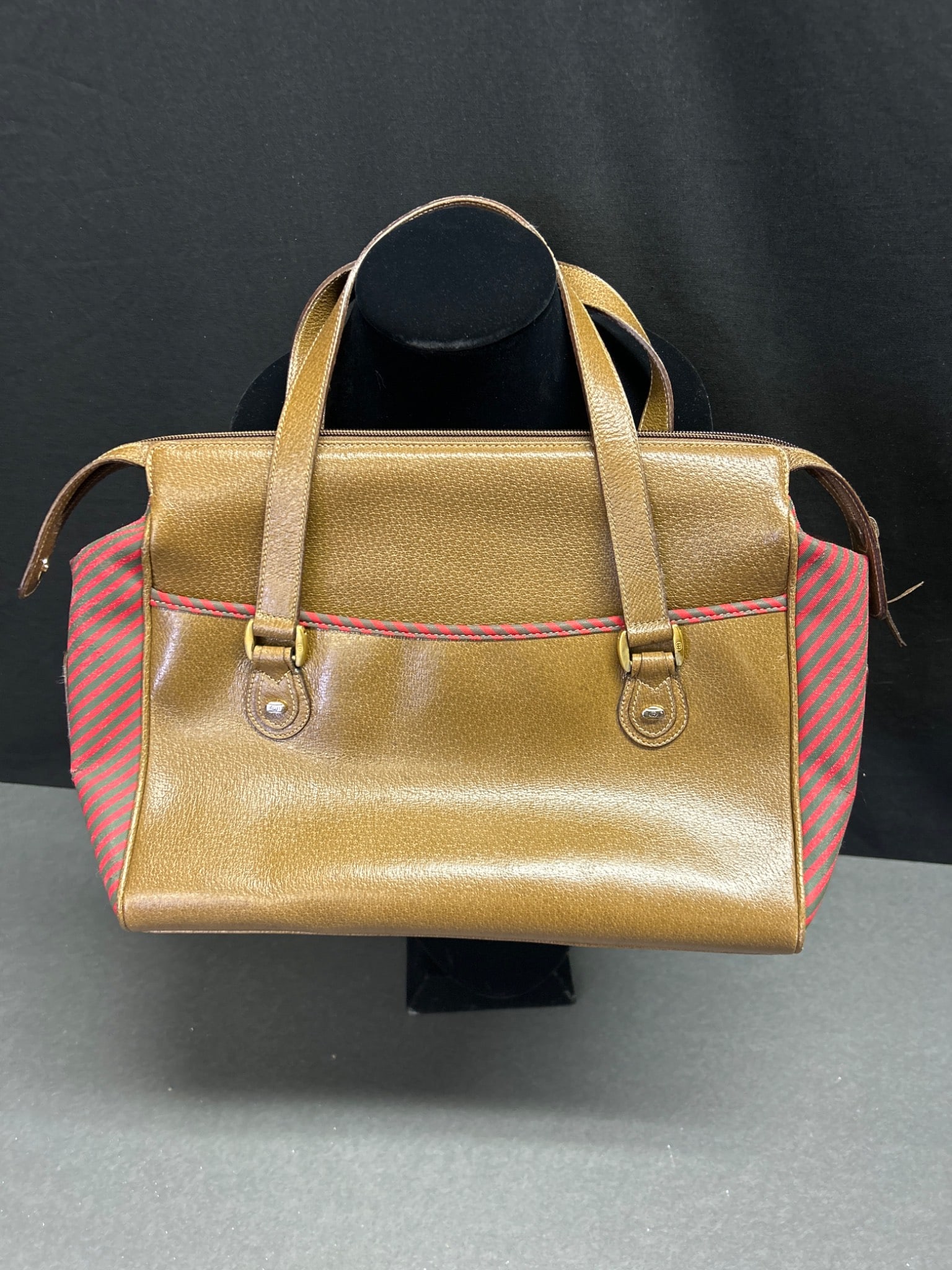 Gucci Accessory Collection Metallic Gold and Red Tote Bag: This is a Gucci Accessory Collection tote bag in metallic gold leather with red and green plaid fabric accents. The interior is lined and features a zippered pocket, with a Gucci 'Made in Italy'
