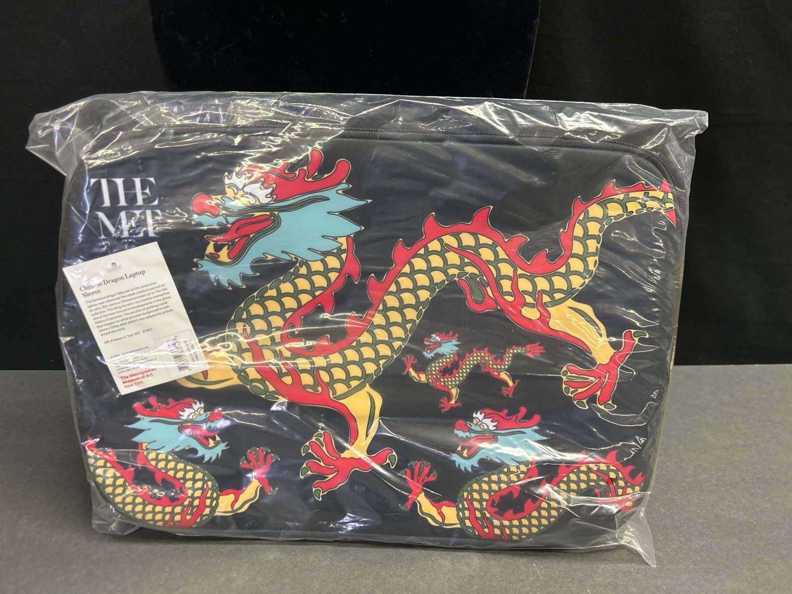 Chinese Dragon Laptop Sleeve from The Metropolitan Museum of Art: This Chinese Dragon Laptop Sleeve features a vibrant dragon motif adapted from The Met collection's early 15th-century Chinese porcelain jar. Derived from the Ming dynasty, the design exemplifies