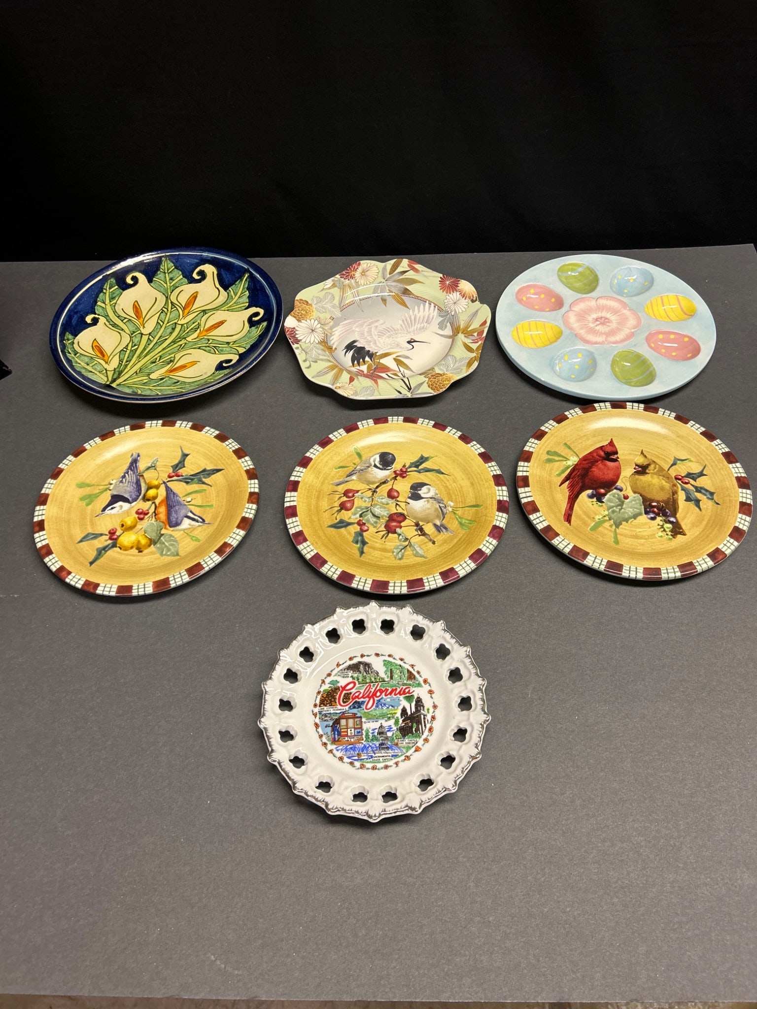Decorative Plates Including Lenox, Spode, and Hand-Painted Pieces: This lot includes a set of decorative plates featuring various designs and manufacturers. Highlights include a Lenox 'Winter Greetings' plate, a Spode 'Japanese Heron' plate with a 2005 copyright