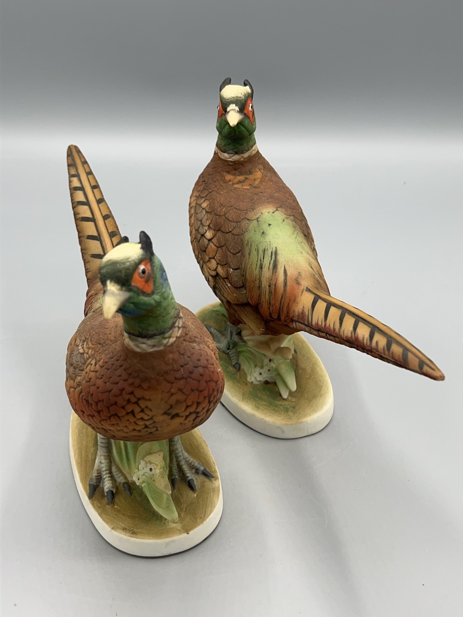 Lefton China KW 670 Pheasant Figurines Pair: Lefton China hand-painted porcelain pheasant figurines, model KW 670, marked Pheasant on the base. Made in Japan. Each figurine measures approximately 6 1/2 inches in height. Both retain original