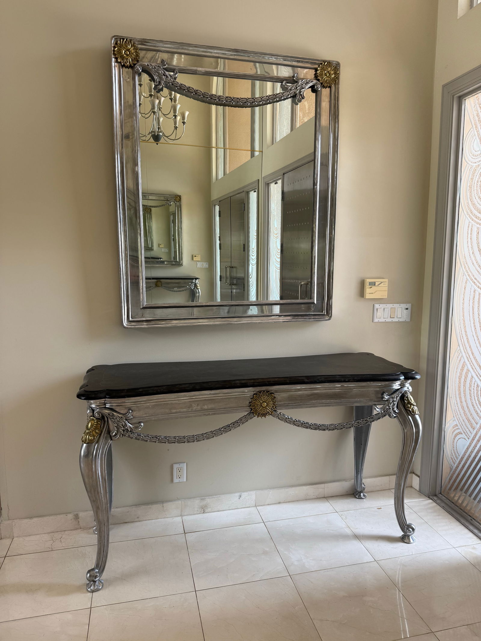 Table and mirror: Console table and mirror silver scroll table 65 inches long and 21 inches deepMirror is 37 high and 48 wideOrnate Commode and Large Mirror – A beautifully crafted furniture set showcasing detailed c
