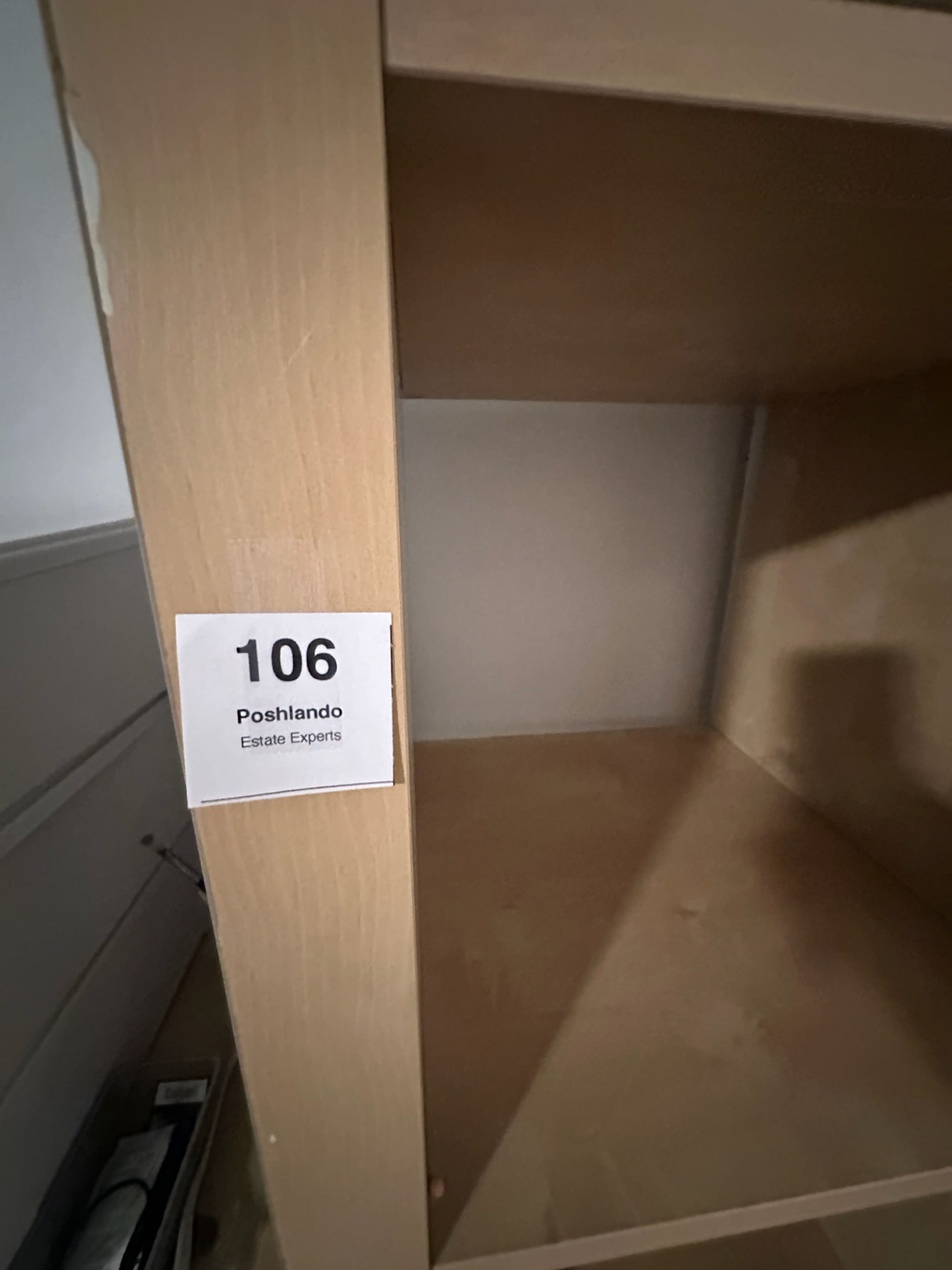 Tall Wooden Bookshelf: Natural wood veneer bookshelf with four fixed shelves. Tall, narrow profile, ideal for storage or display. Some scuffs and wear consistent with use.