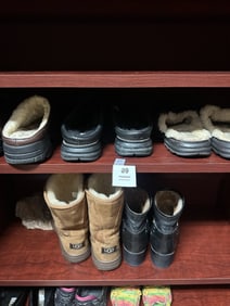 A collection of authentic UGG Australia boots and slippers in mixed styles and colors.