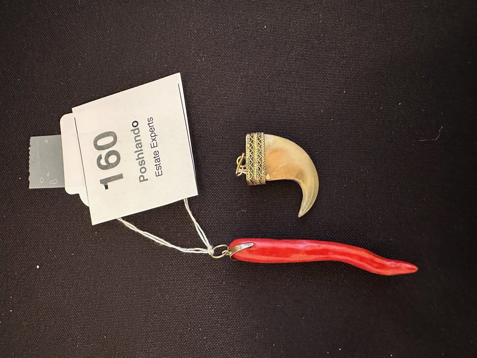 Italian Coral Cornicello & Gilt-Mounted Claw Pendants: Red Coral Cornicello (Little Horn), traditional Italian good luck charm carved in branch form, symbolizing protection against the malocchio (evil eye).Natural Claw Pendant, capped in decorative gilt f