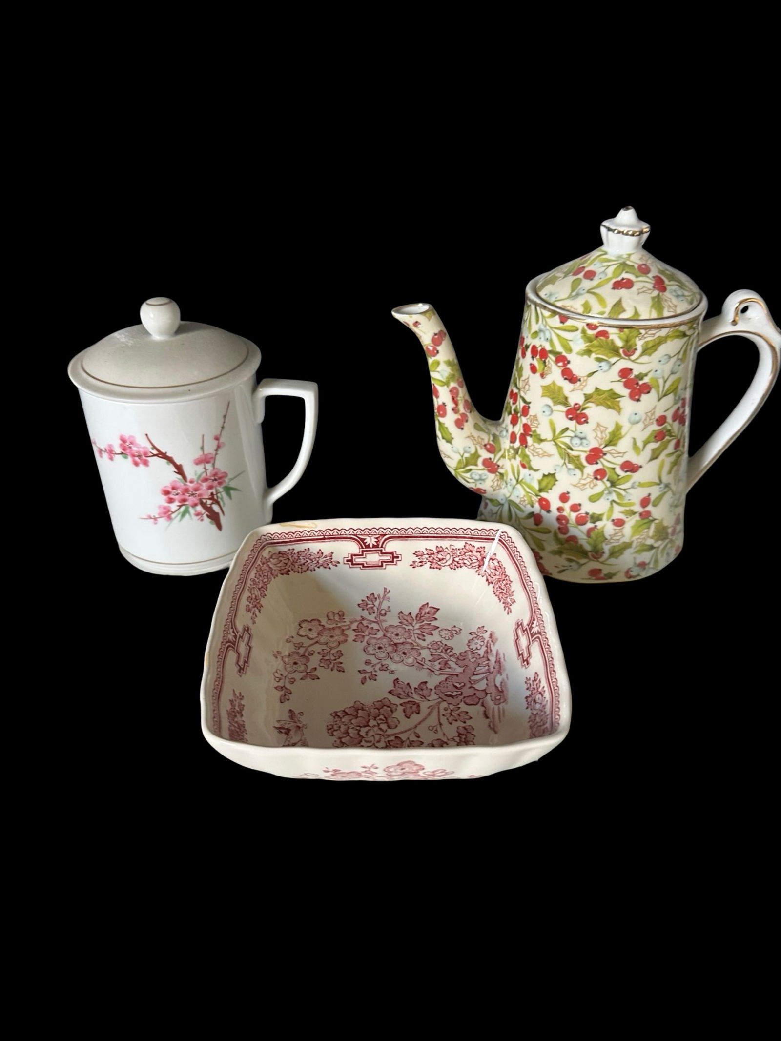 Assorted Porcelain & Ceramic Serveware (3pcs): Charming trio of vintage porcelain and ceramic pieces including:Floris London square bowl with red transfer floral design.Holiday holly berry patterned porcelain coffee/teapot with lid.White porcelain