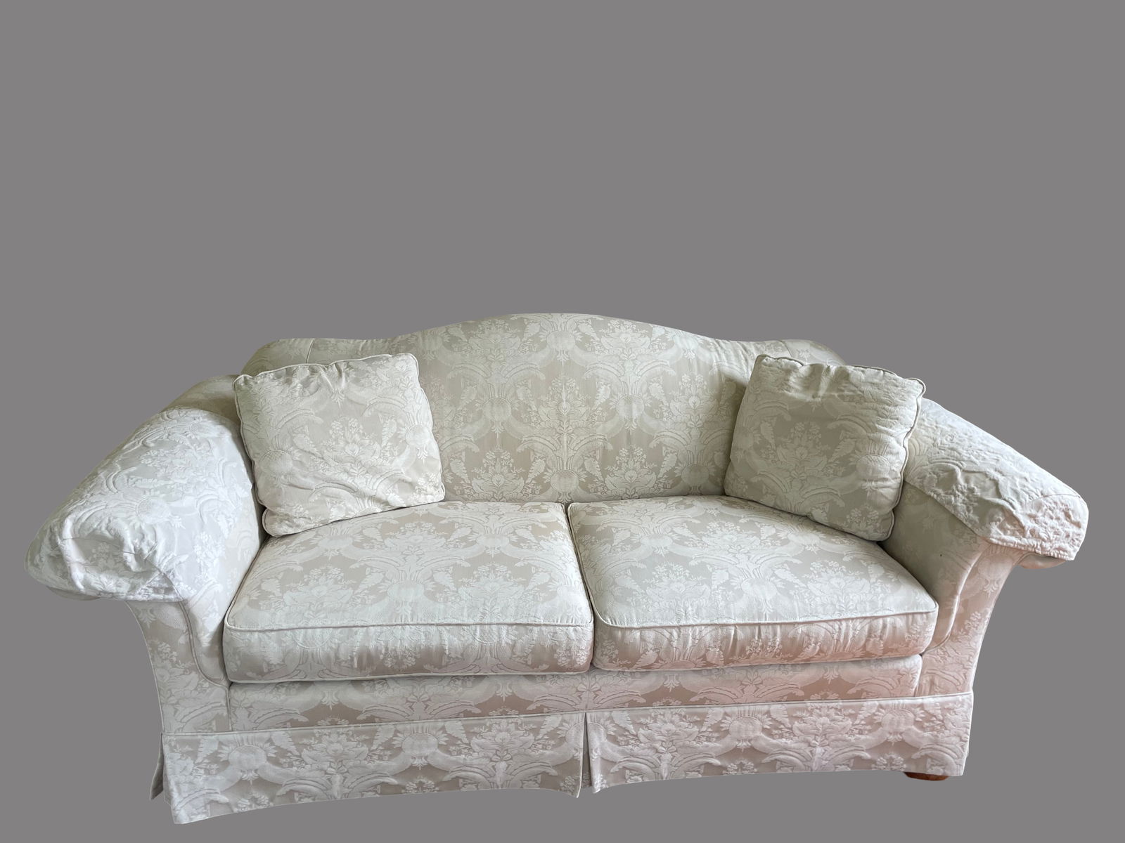 Sherrill Upholstered Two-Cushion Sofa with Jacquard Floral Pattern: Sherrill two-cushion sofa featuring a jacquard floral upholstery in an off-white hue. Includes two matching loose back pillows and attached arm covers. Upholstery exhibits a subtle sheen with floral p