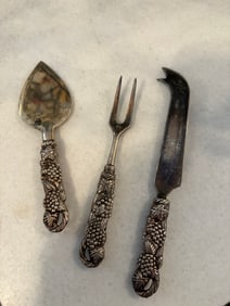 Three Silver-Plated Serving Utensils with Ornate Grapevine Handles