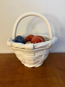Collection of Polished Stone Eggs in Decorative Ceramic Basket