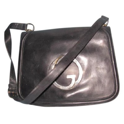 ONE OF A KIND VINTAGE ORIGINAL RE- RELEASED BY GUCCI! * For sale is a RARE, vintage, supple, black: ONE OF A KIND VINTAGE ORIGINAL RE- RELEASED BY GUCCI! * For sale is a RARE, vintage, supple, black leather, Gucci 'Blondie' saddle bag style shoulder bag with an Xlarge, gold 'GG' cut-out at the cente