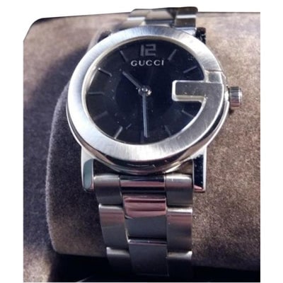 For sale is a Swiss made, Gucci, stainless steel watch with a round, black 'G' face, bracelet style (1 of 4)