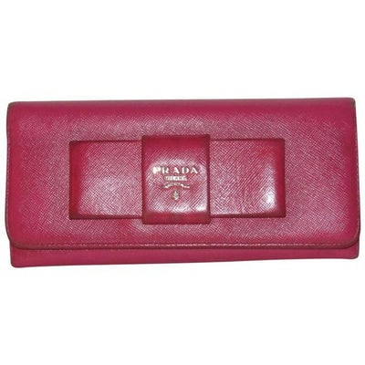 For sale is a PRADA, rose red colored saffiano leather, zip around style, extra large wallet with: For sale is a PRADA, rose red colored saffiano leather, zip around style, extra large wallet with lots of small and large compartments, zip pockets, lots of card slots, and an XL bow accent! This is a