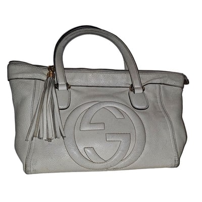 For sale is a Gucci Soho Zip Top ivory textured leather two-way satchel with an XL Tassel zipper: For sale is a Gucci Soho Zip Top ivory textured leather two-way satchel with an XL Tassel zipper pull, gold hardware, quilted GG on the side, & a detachable strap. Inside, it is lined with a very