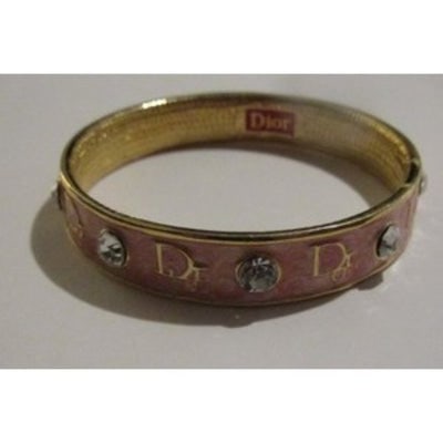 For sale is a NIB, Christian Dior, gold and pink enamel, bangle style bracelet with large Swarovski: For sale is a NIB, Christian Dior, gold and pink enamel, bangle style bracelet with large Swarovski crystals, the Dior logo, and its Dior pouch/box! The bracelet is gorgeous and unique! It is a classi