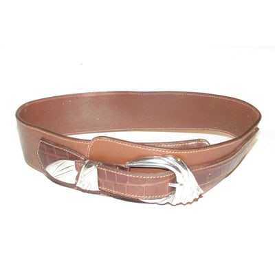 For sale is a vintage Gucci, wide, asymmetrical, brown crocodile & smooth leather belt with: For sale is a vintage Gucci, wide, asymmetrical, brown crocodile & smooth leather belt with sterling silver hardware! This one of a kind belt by Gucci is the perfect accessory for those of us who