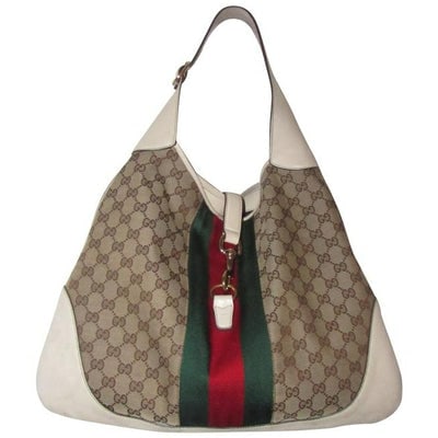 *** CAROLDIVA.COM AUTHENTICATED! *** For sale is an extra large, triangular shape, Gucci, Jackie- O: *** CAROLDIVA.COM AUTHENTICATED! *** For sale is an extra large, triangular shape, Gucci, Jackie- O hobo bag in white leather and brown large G logo print canvas with a red and green center Sherry str