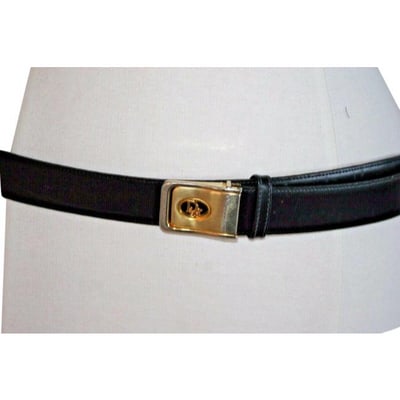 Dior Black & Brown Reversible Leather Belt: For sale is a vintage, Christian Dior, reversible, brown and black leather belt with an Art Deco look, two-tone, engraved logo buckle with a hook that slides into a hole to secure! The belt is classic