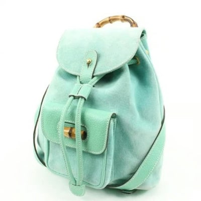 Tom Ford era Gucci aqua suede & leather messenger bag/backpack: This style was recently re-released by Gucci and costs ~ $4K!For sale is a Tom Ford era, Gucci, aqua color, suede and leather, messenger bag/backpack with an exterior pocket, drawstring top closure, t