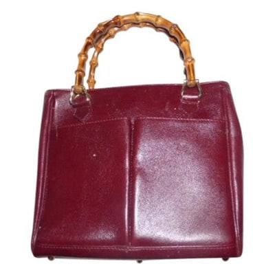 Gucci Burgundy Leather Original Diana Satchel With Bamboo Handles: Just re-released by Gucci as the 'Diana' for ~ $3K to $4K!For sale is a Gucci, mod look, burgundy leather, tote or shopper with two bamboo handles, a footed bottom, and exterior pockets! It has the 19