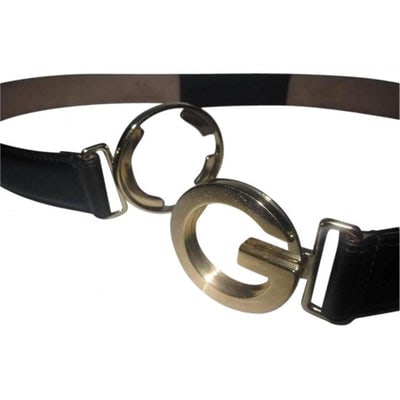 NWoT black leather Gucci belt: For sale is a Gucci, NWOT, black leather belt with elastic portion and bold, gold, round G logo.buckle! The belt is classic yet very eye-catching! The belt is 1.25" wide in black, leather. It does not
