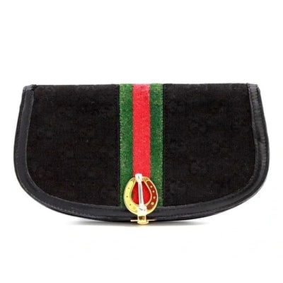 Rare, early Gucci, black Gucissima print canvas and black leather, semi-circular shape, wallet with: For sale is a rare, early Gucci, black Gucissima print canvas and black leather, semi-circular shape, wallet with an inlaid red and green Sherry stripe. This rare and early Gucci black Gucissima print