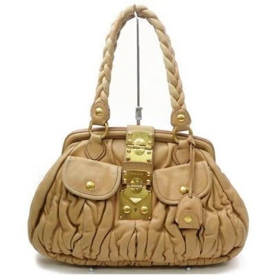 Miu Miu Tan Pleated Matelasse Leather Top Handle Satchel With Locking Clasp & Key: For sale is an AMAZING, Miu Miu, 'Matelasse' buttery beige leather satchel style shoulder purse with two braided leather straps, a hinged opening, two exterior snap close pockets, a key to lock the pu