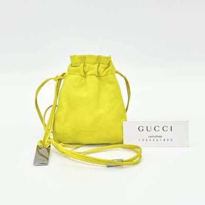 Gucci Tom Ford era yellow leather drawstring top pouch w silver Gucci dog tag: For sale is a Gucci Tom Ford era yellow leather drawstring top pouch with an engraved silver Gucci dog tag pendant. This is a versatile & fun piece from the 1990s that is extremely hard to find in