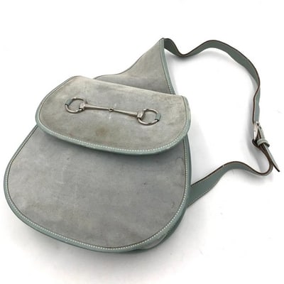 Gucci Tom Ford era grey leather & suede 1955 Horse-bit messenger/sling backpack: Gucci Tom Ford era grey leather & suede 1955 Horse-bit messenger/sling backpack with chrome hardware & a large horse-bit accent on the flap. This must have Gucci piece from the coveted To