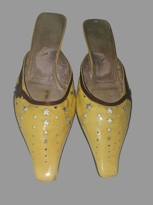 Prada kitten heel mules in yellow, brown, & dark red with star cut outs: For sale is a pair of Prada 1990's color block kitten heel mules in yellow, brown, & dark red with star cut outs & 2" heels in size 36.5. These iconic mules showcase the bold aesthetic th