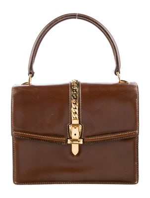 Gucci 1969 Sylvie chestnut brown leather top handle Kelly bag with a gold zipper accent: ONE OF A KIND VINTAGE FIND!! For sale is a RARE, Gucci, 1969 Sylvie chestnut brown leather, top handle Kelly bag with an envelope top, with a bold gold zipper accent down the cent