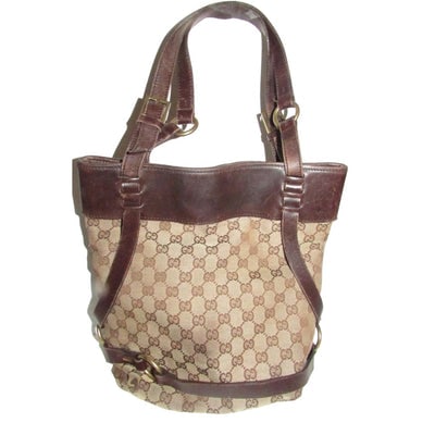 Gucci brown Guccissima print canvas & leather strappy cylindrical tote with brass accents: For sale is a Gucci brown Guccissima print canvas & leather strappy cylindrical tote with brass accents. It is a large, unique take on a tote bag by Gucci that will look great with lots of outfits