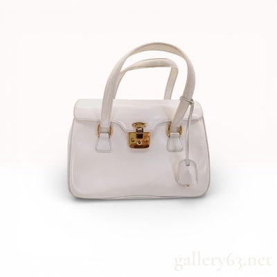 Gucci white leather Lady Lock satchel w gold hardware & key: Discover timeless luxury with this stunning Gucci white leather Lady Lock satchel, a coveted piece from the Italian fashion house's prestigious collection. Crafted from pristine white leather, this st