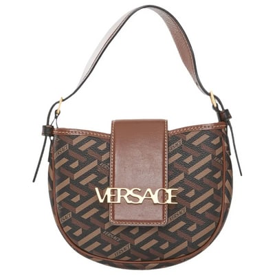 Versace 'La Greca Signature' Two-Way Shoulder Bag in brown: Versace 'La Greca Signature' Shoulder Bag in brown. Features a monogram coated canvas shell with brown leather trim. Logo embellished flap closure with concealed snap. Buckle top handle. Detachable ch